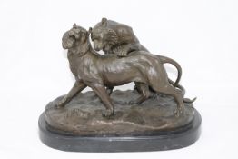 A contemporary bronze figure of two lions at play, signed Walton, purchased from The Bronze Gallery,