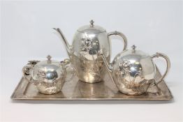 A four piece silver tea service, comprising of twin-handled serving tray, teapot,