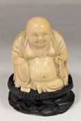 A 19th century Chinese carved ivory figure of a seated Buddha, holding prayer beads,