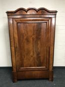 A 19th century mahogany single door cabinet, with arch top pediment, width 103cm.
