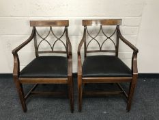 A pair of 19th century mahogany armchairs upholstered in black fabric, width 55cm.
