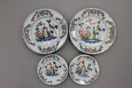Two pairs of 18th century tin glazed delft plates, diameter of the largest plates 34.5 cm.