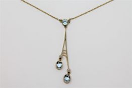 An aquamarine three stone pendant suspended upon a 9ct gold chain.