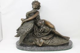 A bronze figure of Leda and the Swan, on marble base, width 46cm.