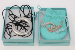 Two Tiffany & Co sterling silver pendants (one on chain),