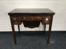 A mid 19th century inlaid rosewood foldover top work table, on tapered legs,