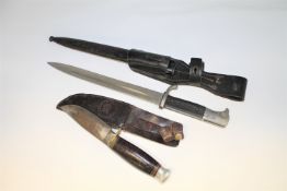 A German bayonet in sheathe, together with a hunting knife stamped 'William Rodgers. I Cut My Way'.