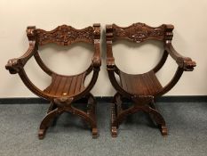 A pair of carved Savonarola armchairs.