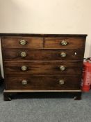 A George III mahogany chest of five drawers, on bracket feet, width 112 cm.