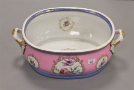 A continental porcelain twin handled basin or foot bath, with blue crossed swords mark to base,