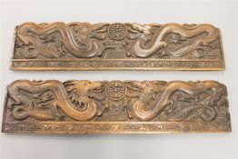 A pair of late 19th century Chinese carved wooden panels depicting dragons, length 91cm.