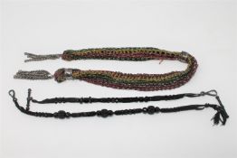 A miser's purse, together with two jet Albert chains.