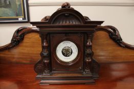 A Victorian aneroid barometer in carved mahogany case.