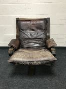 A mid 20th century brown leather swivel relaxer chair, width 75cm.