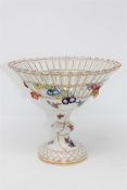 A continental porcelain pedestal fruit bowl, with blue crossed swords mark to base, height 19cm.