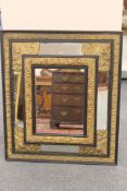 A 19th century ebonised and parcel gilt repousse framed mirror, height 74cm.