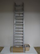 An aluminium four section ladder together with three boxes of anti climbing spikes,