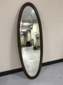 An inlaid oval mahogany dressing table mirror