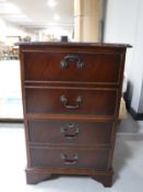 A mahogany two drawer filing chest with brown leather inset panel and inlaid mahogany two tier