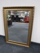 A gilt framed overmantel mirror