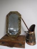A vintage leather luggage case together with an embossed brass framed mirror,