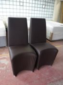 A pair of brown leather high backed chairs