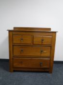 An Edwardian oak four drawer chest