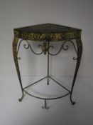 A contemporary cast metal corner whatnot stand