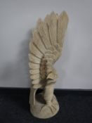 A carved wooden figure of a golden eagle