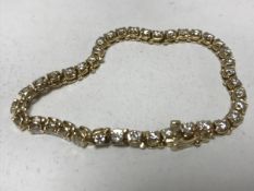 A 14ct gold diamond set tennis bracelet set with thirty-nine diamonds, 16.