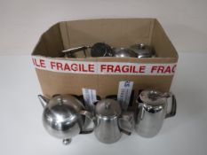 A box containing stainless steel tea services plated spirit kettle