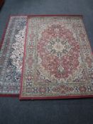 Two Persian design rugs on red ground