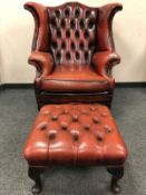 A Burgundy buttoned leather Chesterfield style armchair with matching stool