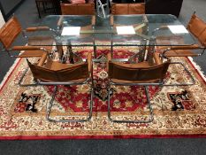A late 20th century glass top dining table on steel support,