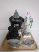 A tray of carved hardwood stands with shells, nineteenth century pottery figure,