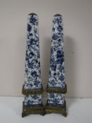 A pair of ormolu mounted blue and white obelisks