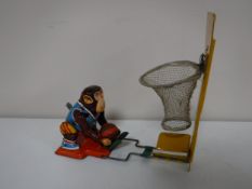 A mid 20th century Japanese tin plate basket ball monkey