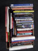 A box of books relating to model making and toys