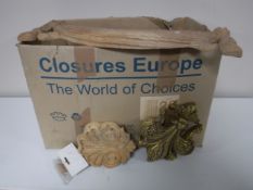 A box of carved wooden cornices and decorations