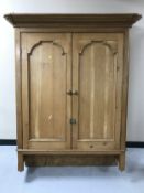 A pine wall mounted cupboard