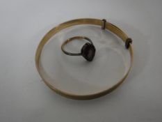 A 9ct gold bangle and a 9ct gold dress ring.