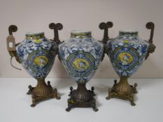 A trio of ormolu mounted blue and white decorative urns