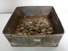 A tin of foreign and British coins