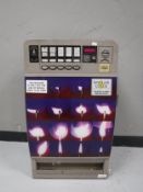 An Azkoyen wall mounted cigarette machine with keys