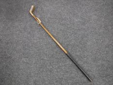 An early twentieth century antique brass headed medium lie putter