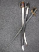 Two Indian swords together with a wooden practice sword