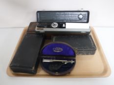 A tray of five cased medical instruments