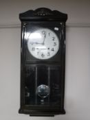 A cased Seikosha 21 day wall clock with pendulum and key