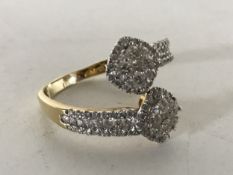 A yellow gold diamond set twist ring, size S.