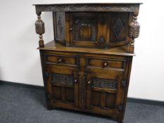 A carved oak buffet backed sideboard